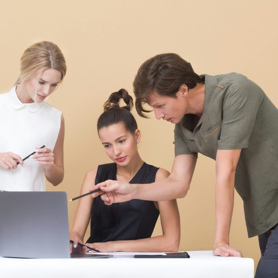 Tres personas mirando a una computadora